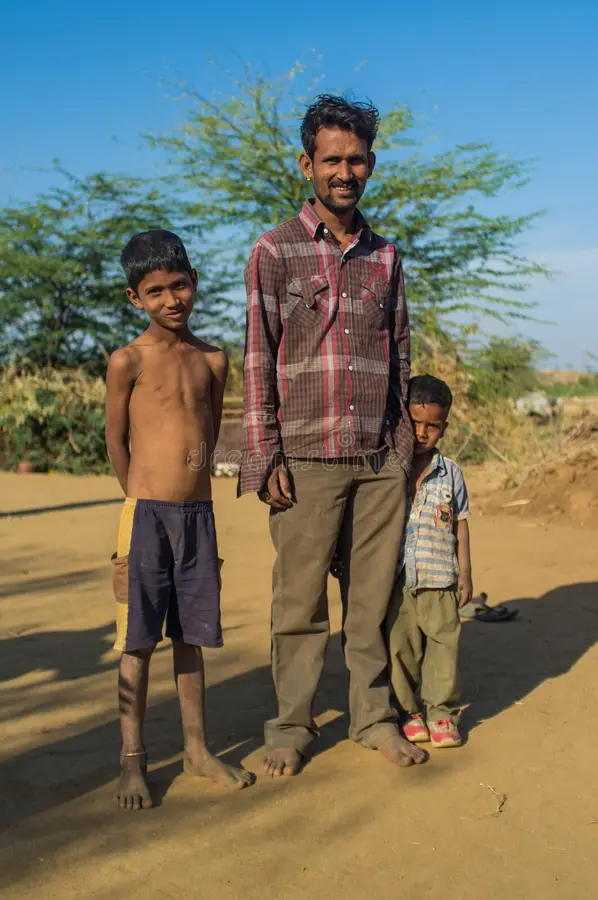 father-two-sons-godwar-india-february-stand-dusty-ground-small-village-godwar-gorwar-southwest-region-55870729